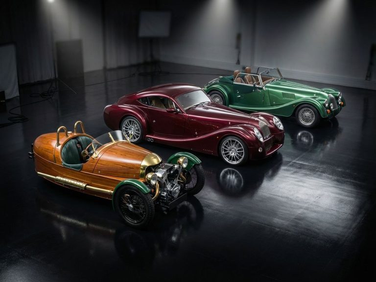 Drie Morgan sportwagens - vintage roadster, Aero 8 en Plus Four - op zwarte ondergrond met dramatische studiobelichting